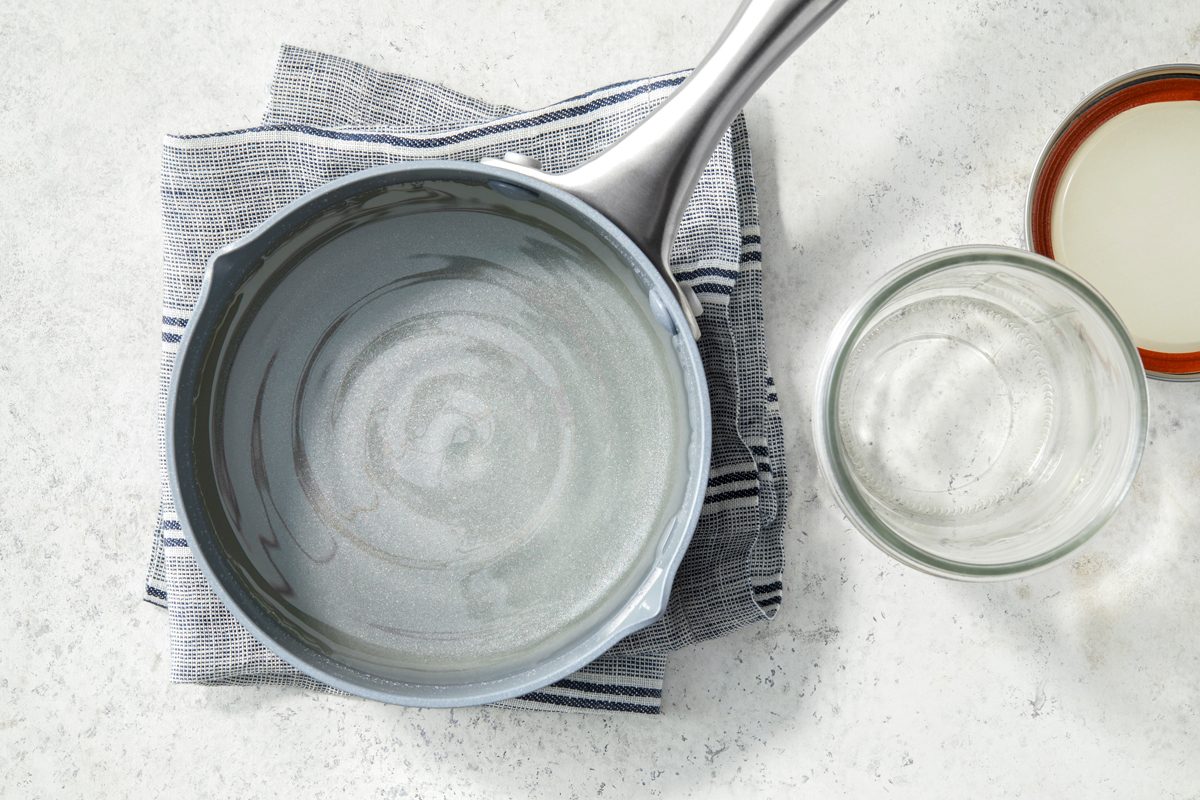 Overhead shot of remove from the heat; cool to room temperature; transfer to a container with a tight-fitting lid; store in the refrigerator for up to 2 weeks; napkin; marble surface