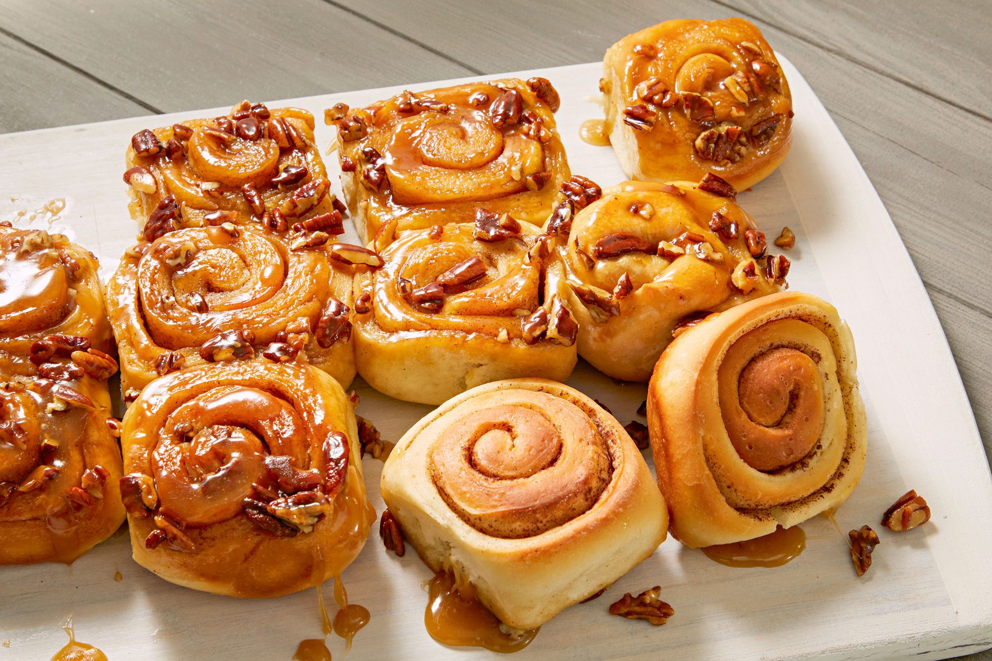 Sticky Buns cut into pieces and serve them on large platter placed on a wooden surface