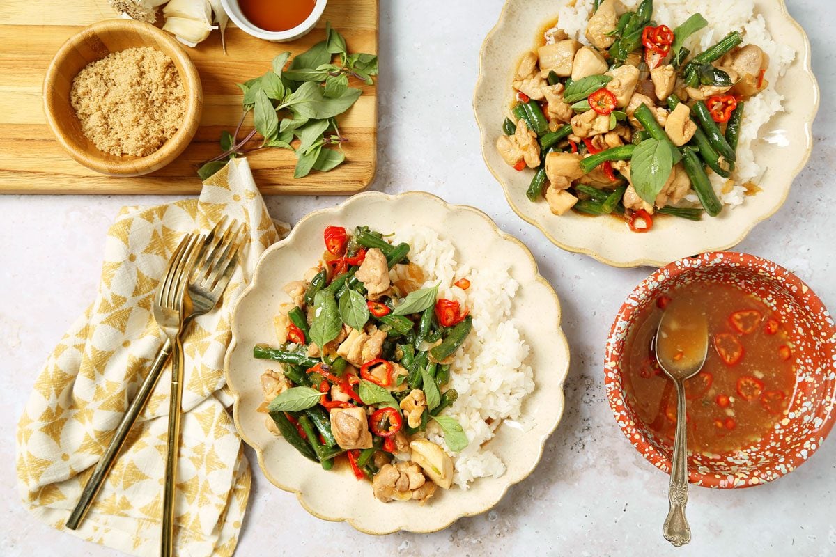 Thai basil chicken served on a plate with jasmine rice.