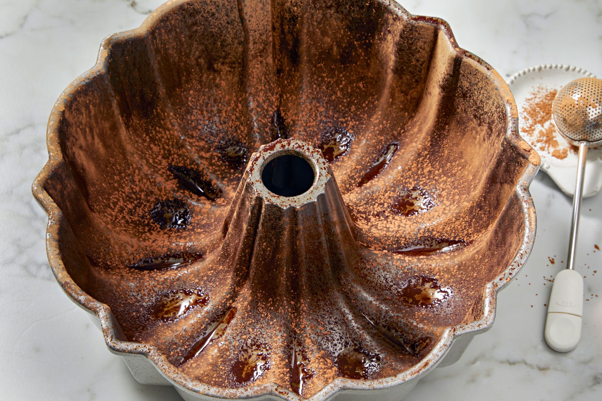 Grease a fluted tube pan; dust with cocoa powder