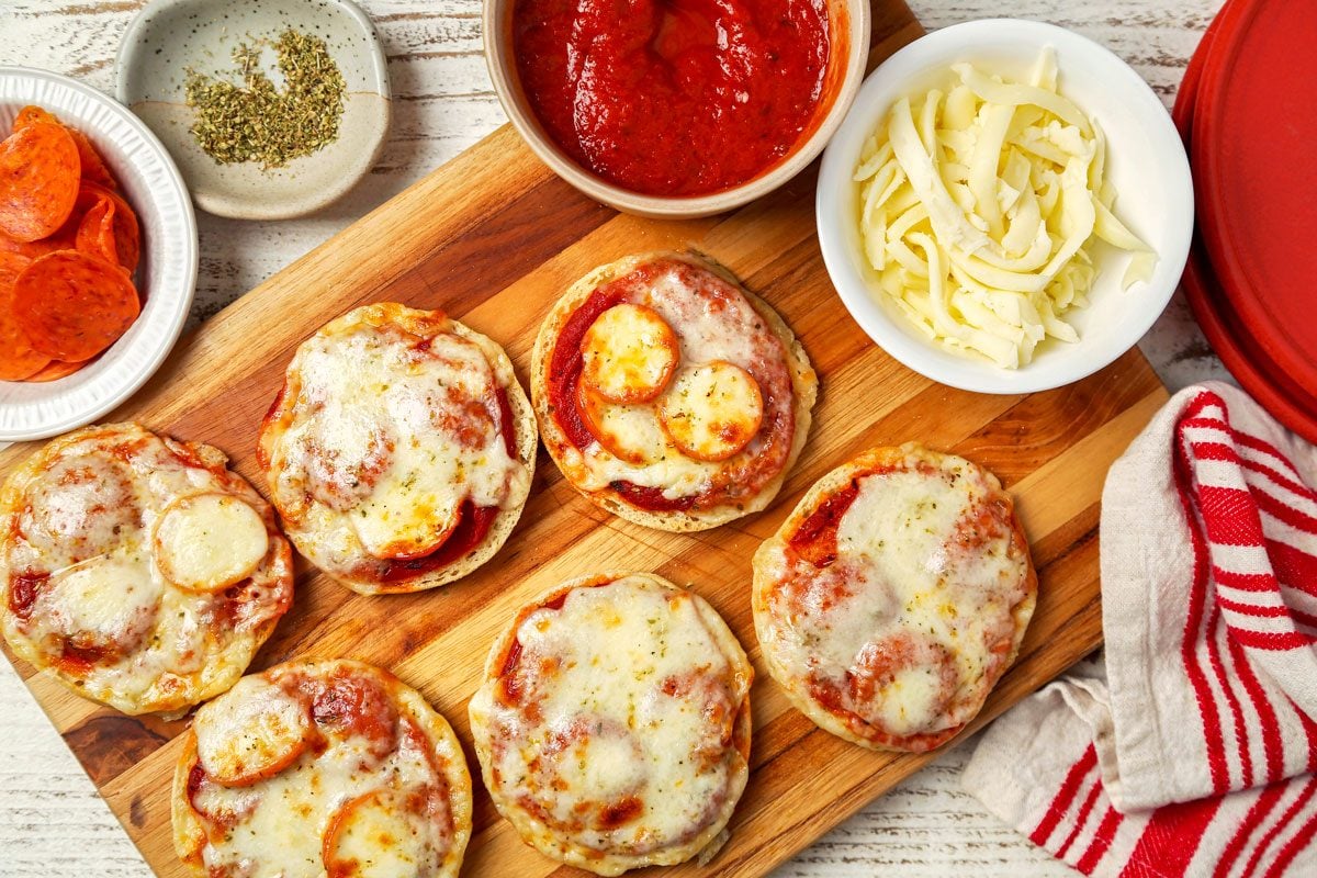 English Muffin Pizzas shot on a white wooden surface; overhead