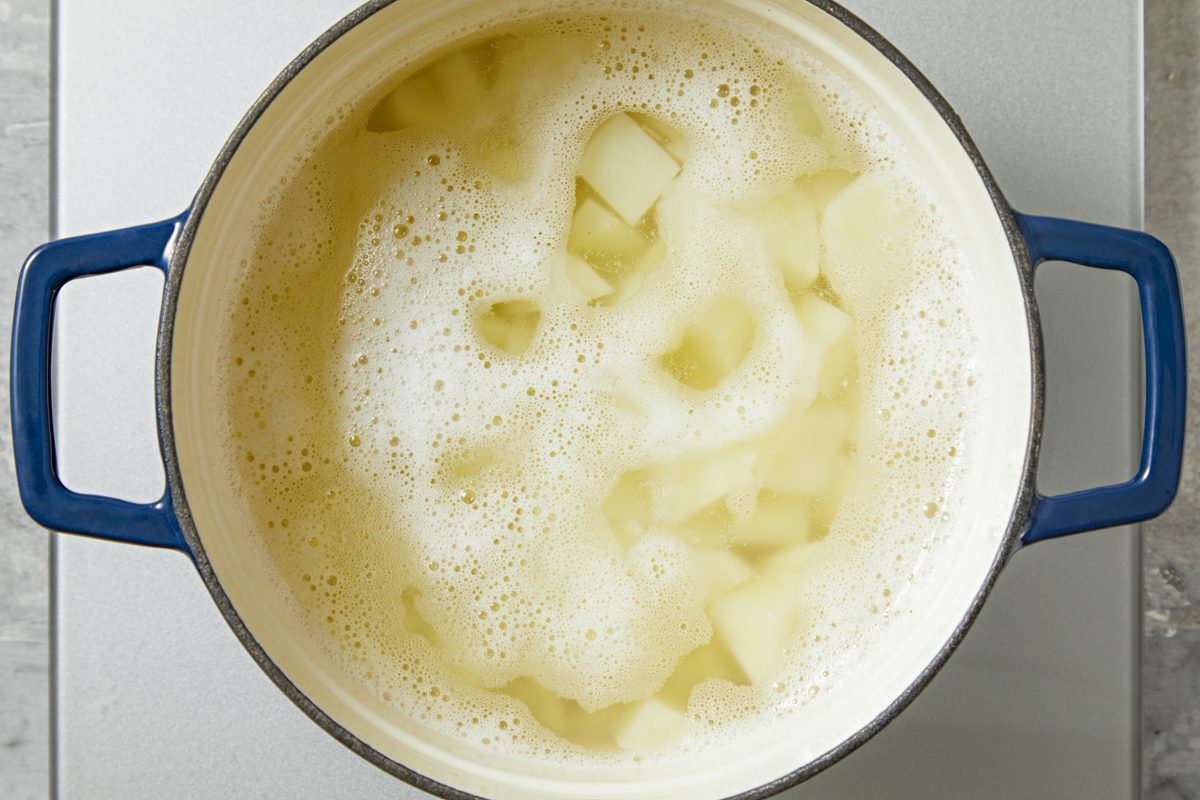 potatoes boiling in water in a saucepan
