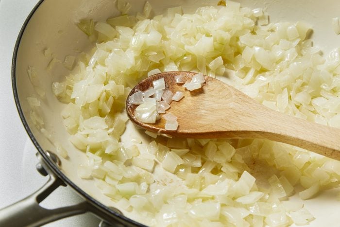 onions being sautéed in a skillet