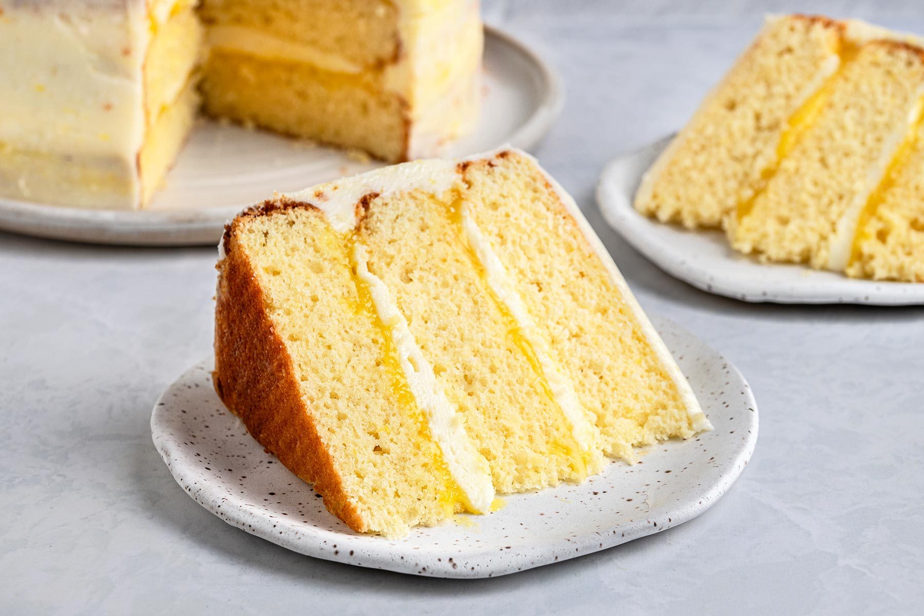 Close up shot of Lemon Curd Cake on top of a grey marbletop.
