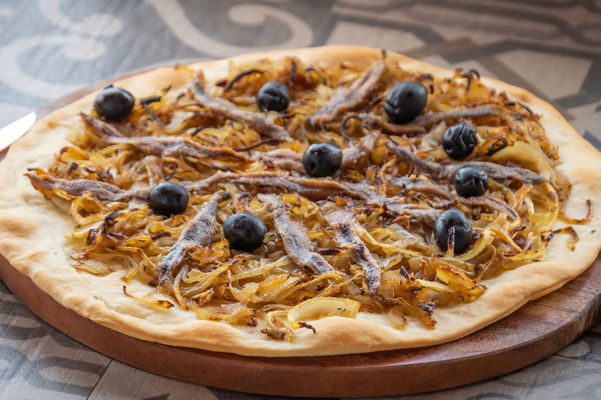 Pissaladiere served on the table.