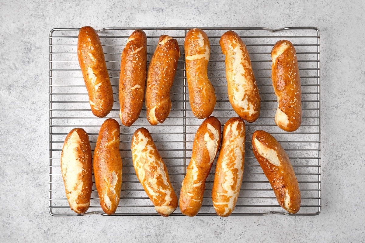 overhead shot of twelve Pretzel sticks arranged on a silver wire rack, the background is a light gray countertop or surface