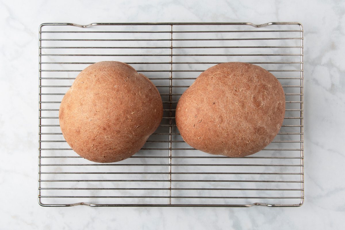 baked dough loaves cooling on wire rack