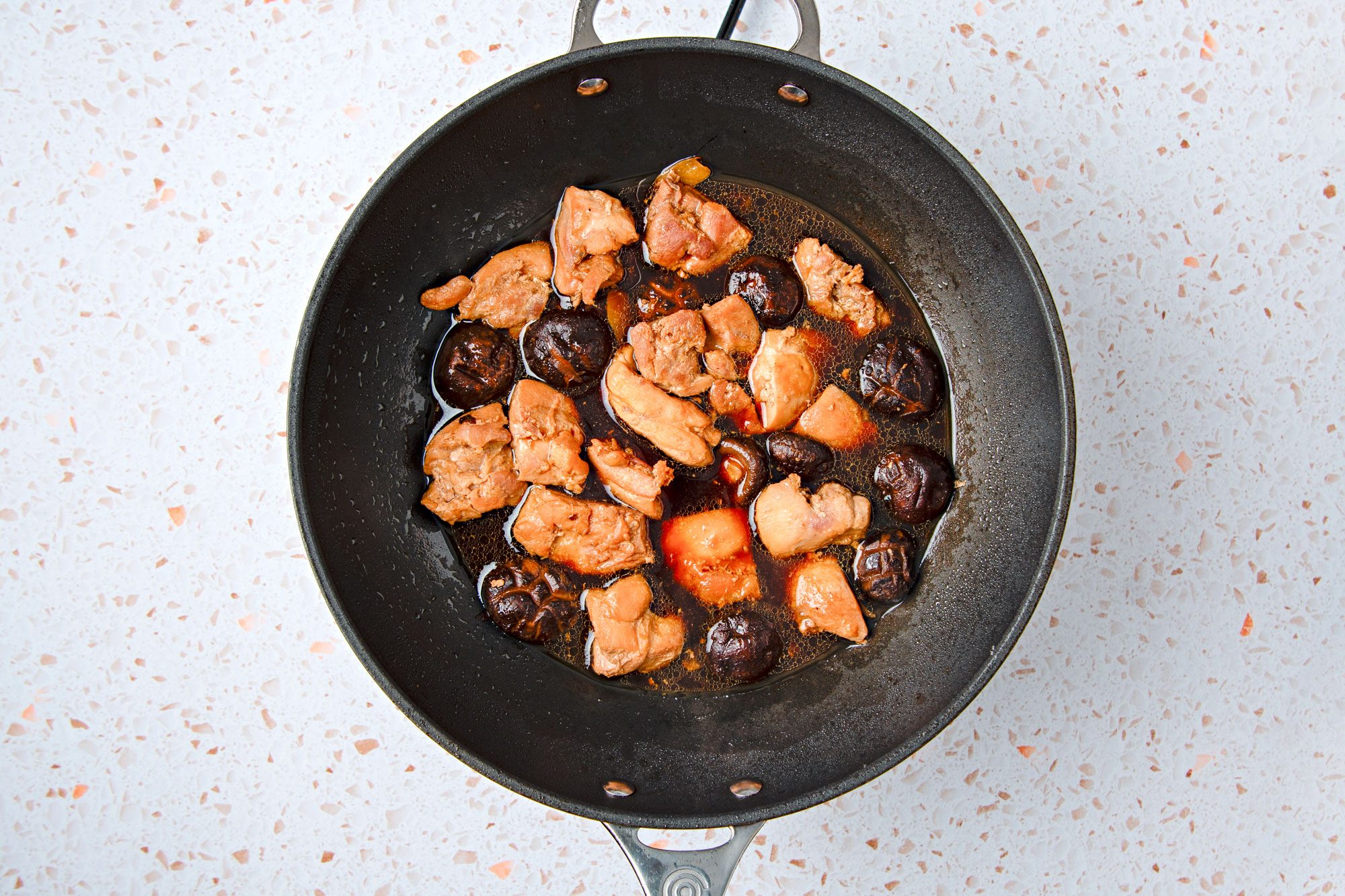 Add wine, soy sauce, water and sugar.