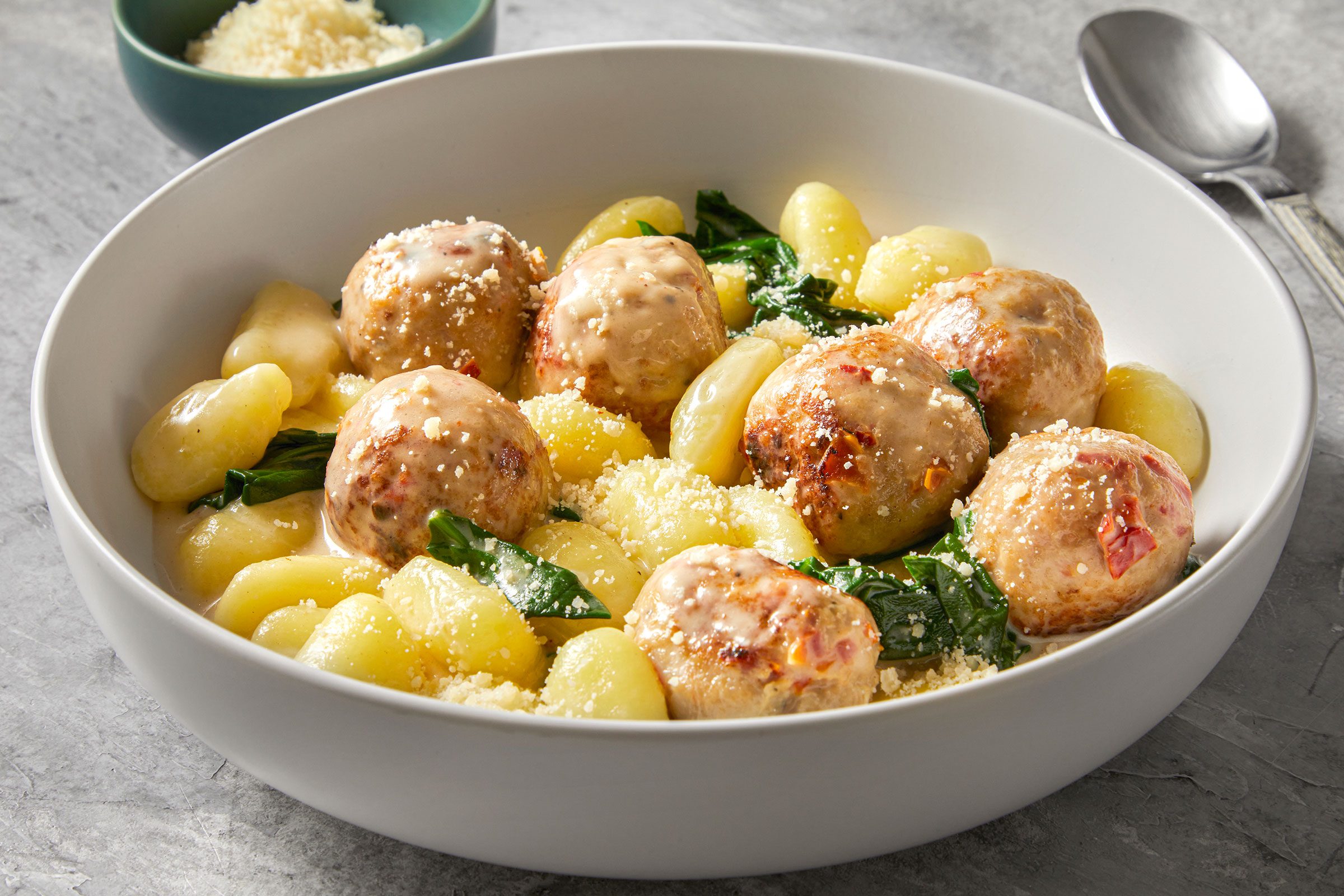 Tuscan Chicken Meatballs With Gnocchi in a white bowl