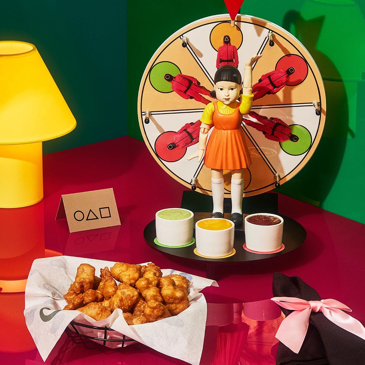 Squid Game themed dish with a spinning wheel and choice of dipping sauces
