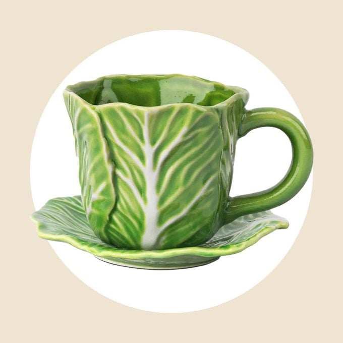 Cabbage teacup with matching saucer on a white and tan background