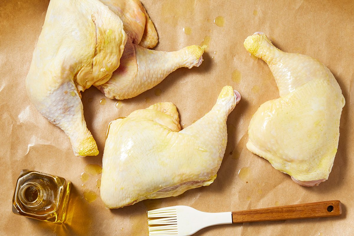 Brush chicken legs with olive oil;