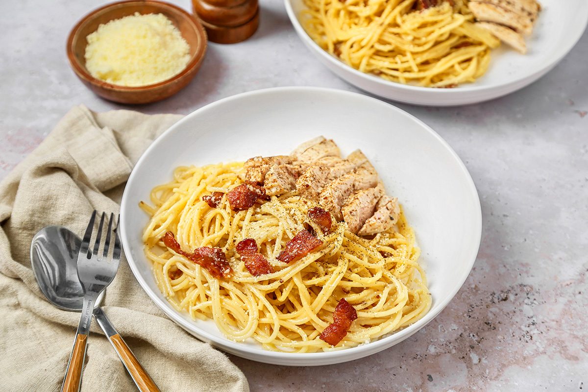 3/4th shot of Chicken Carbonara served in a white bowl