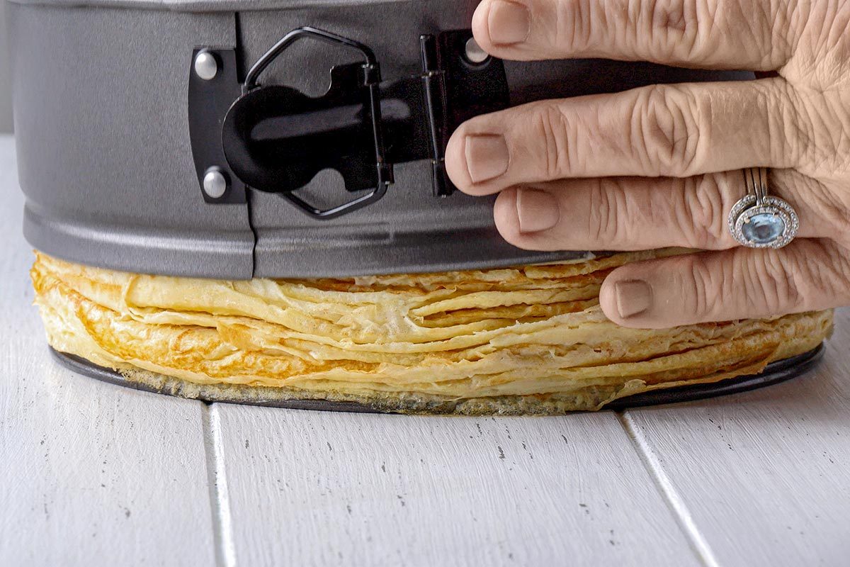 Crepe Cake being removed from springform pan.