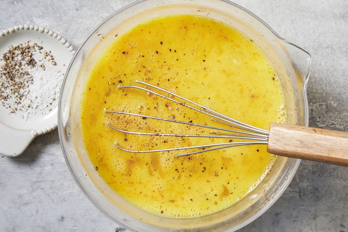 In a small bowl, whisk together eggs, salt, pepper and smoked paprika,