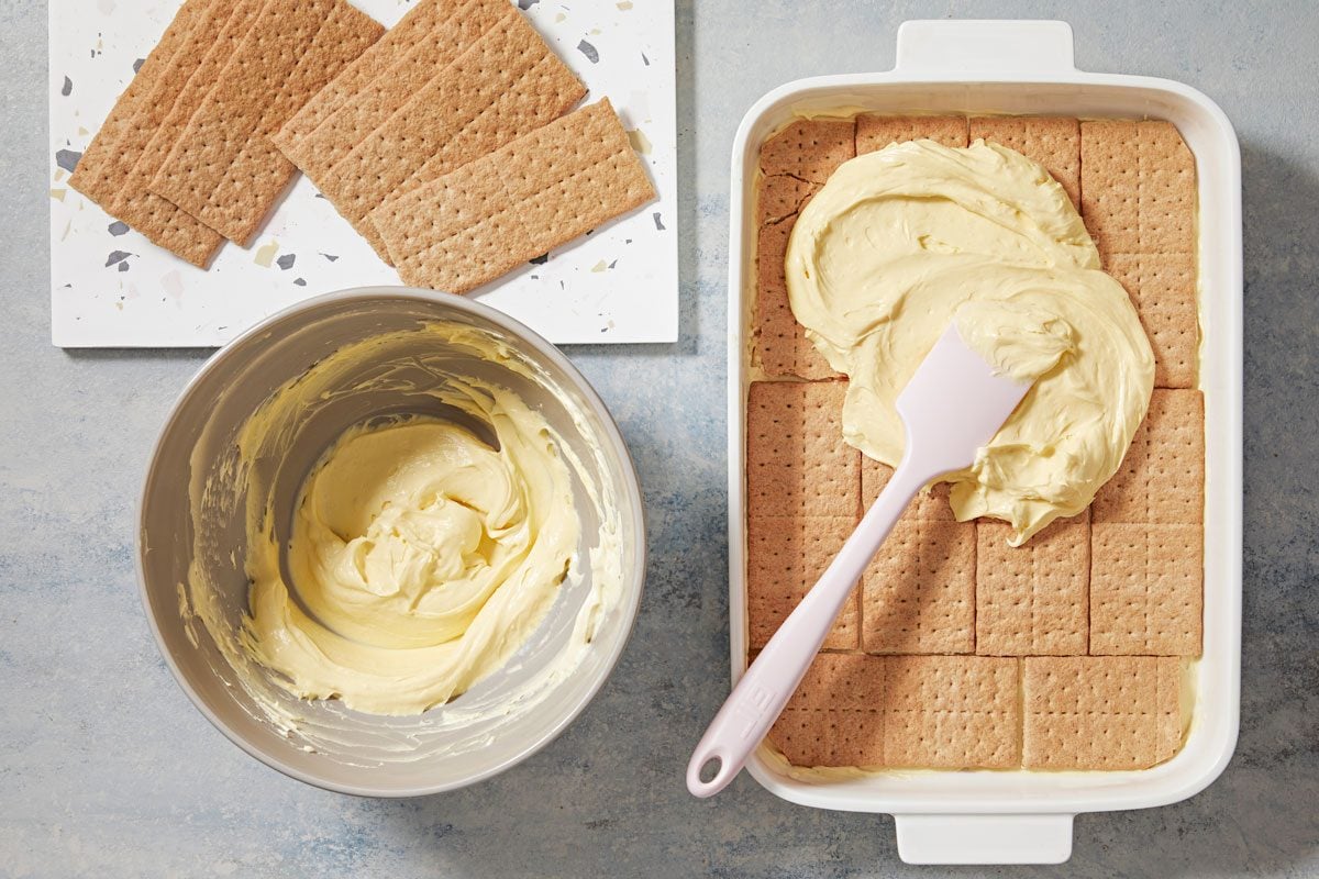 Spread 1/2 of the pudding mixture evenly over grahams, repeat layers