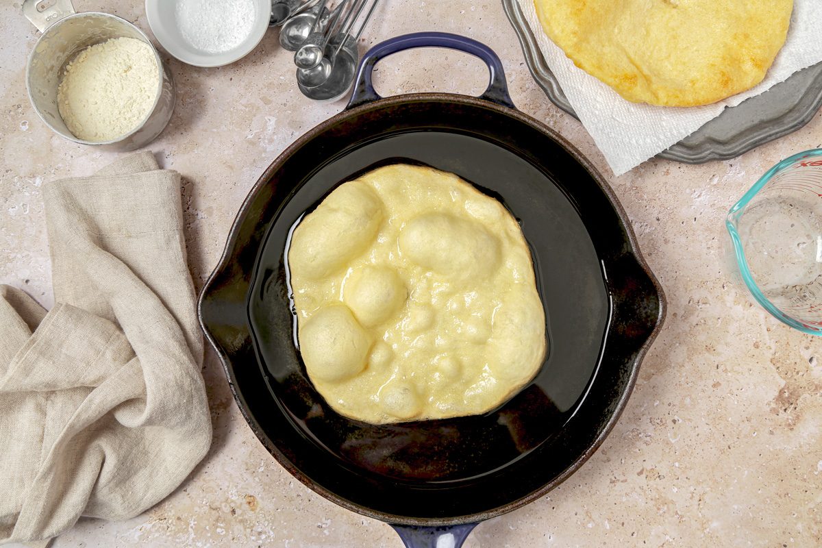 Frying bread circles in hot oil in a large skillet