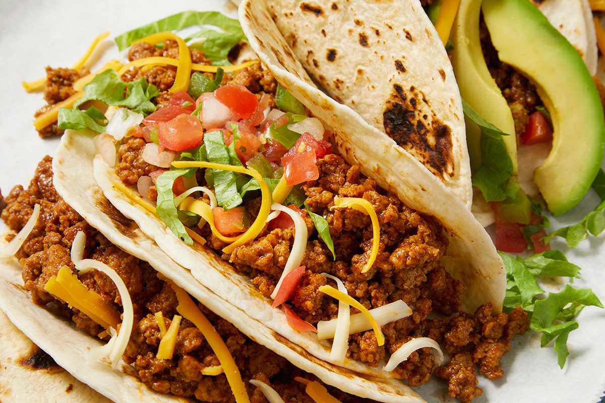 overhead shot of Ground Turkey Tacos, showcasing several soft tortillas filled with a savory mixture of ground turkey