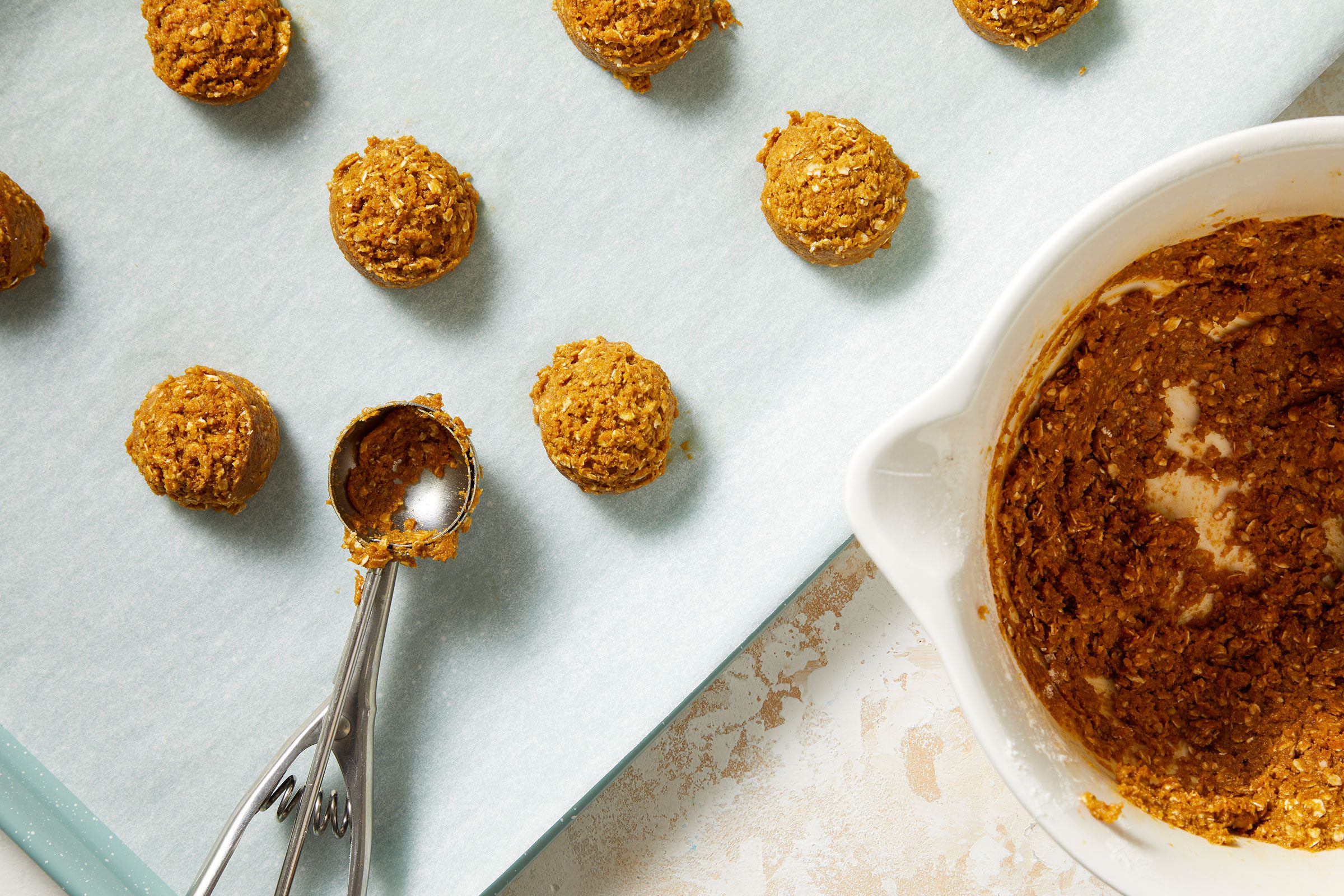 Dropping the dough by tablespoonfuls onto a parchment paper-lined baking sheet