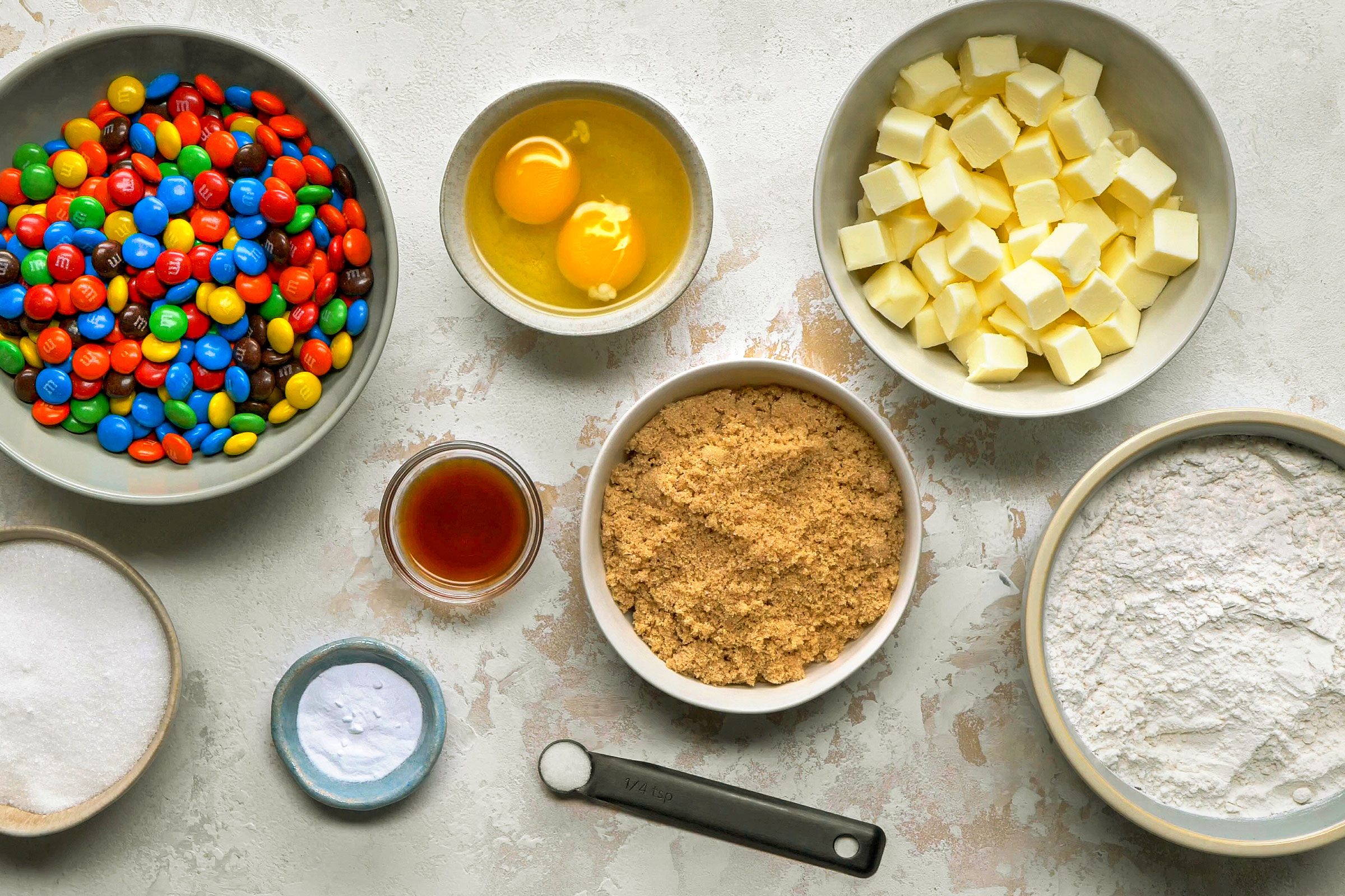 Ingredients for M&M cookies in bowls
