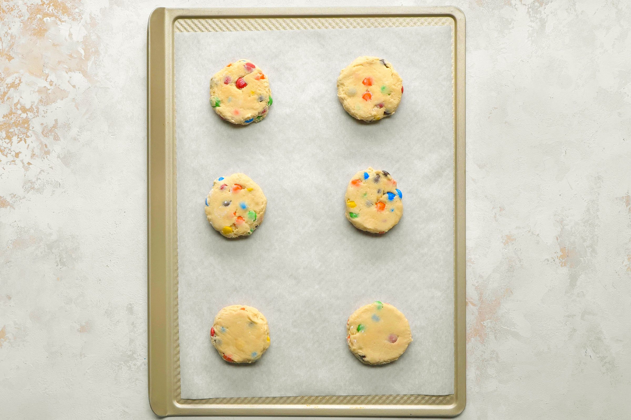 Cookie dough portions 2 inches apart on parchment-lined baking sheets