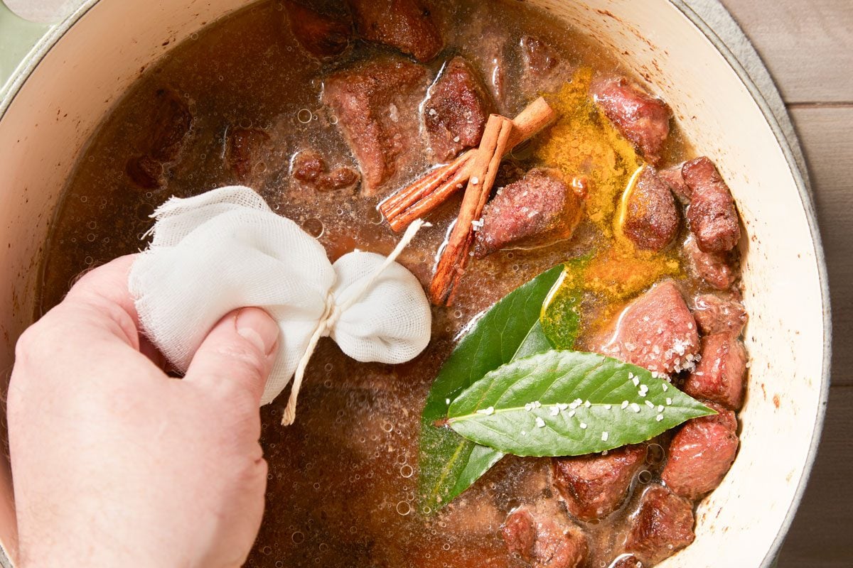 Add to the pot with cinnamon sticks, bay leaves, remaining 1 teaspoon salt and turmeric. Bring to a boil.