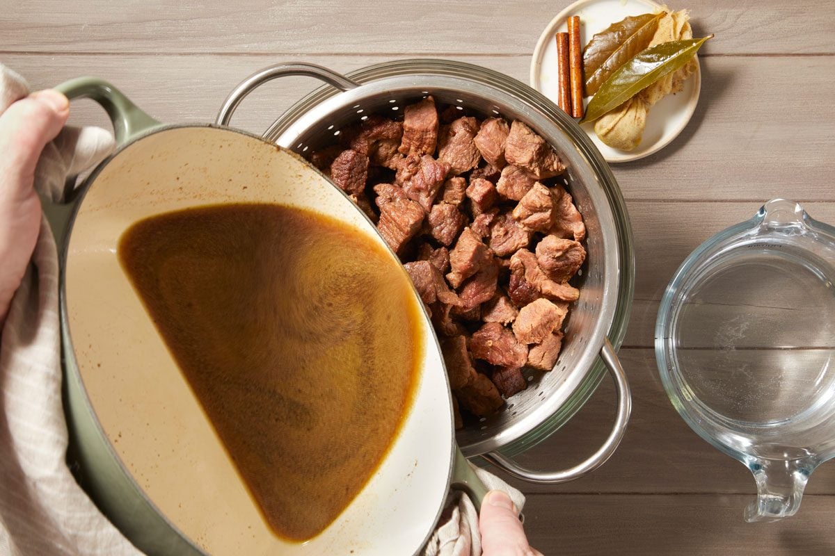 . Strain lamb and stock through a colander;