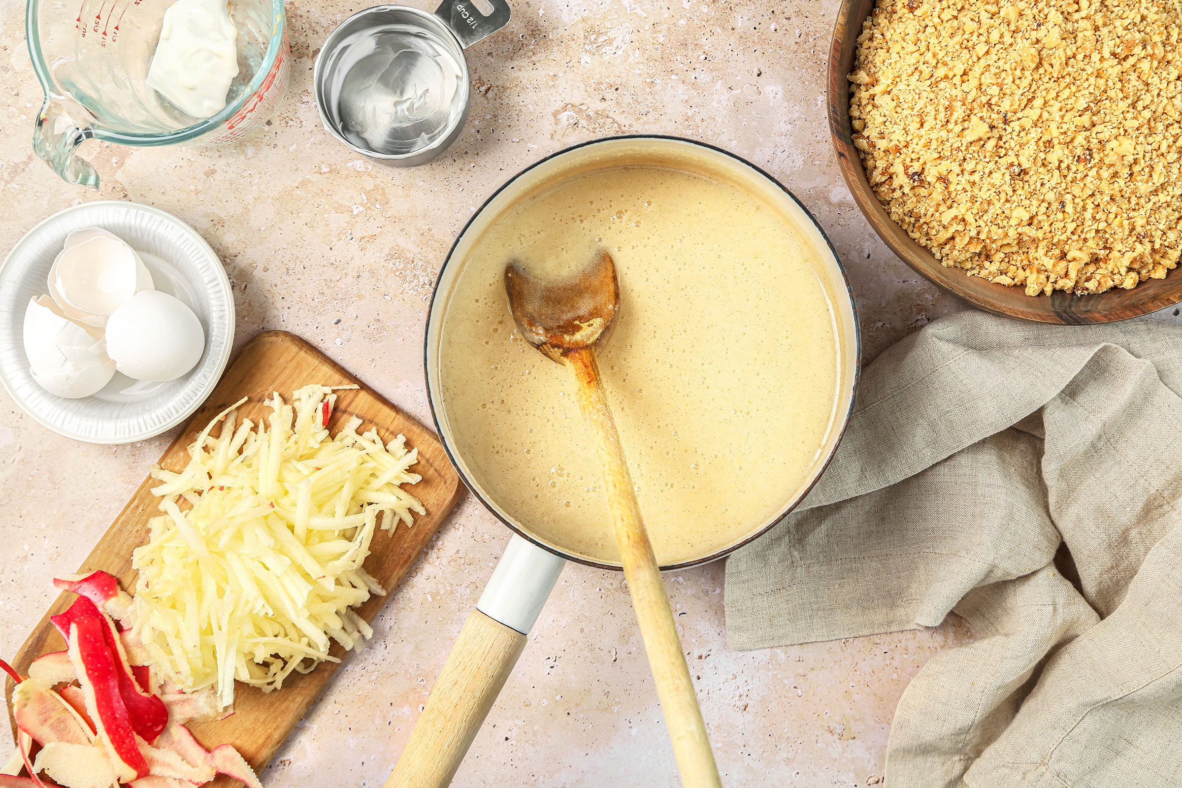 Sugar, butter, egg and cinnamon cooking on medium heat in a large saucepan