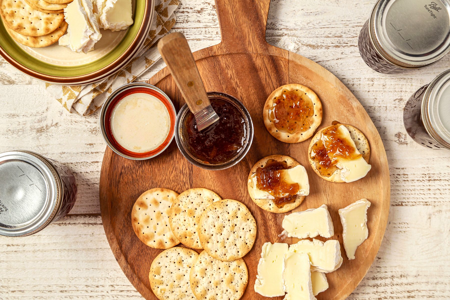 Onion Jam served on a wooden board with crackers and cheese