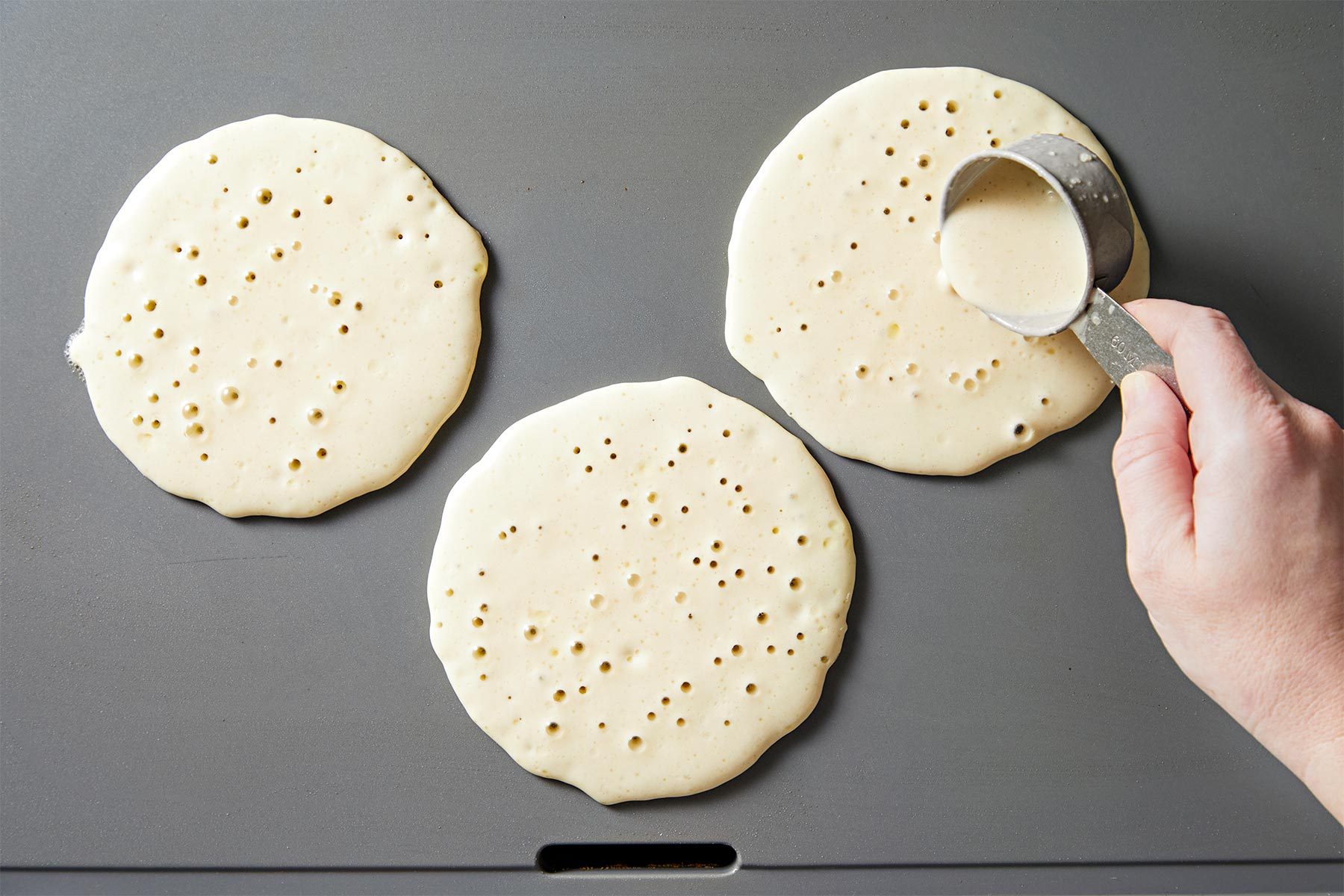 Lightly grease griddle. Pour batter by 1/4 cupfuls onto griddle;