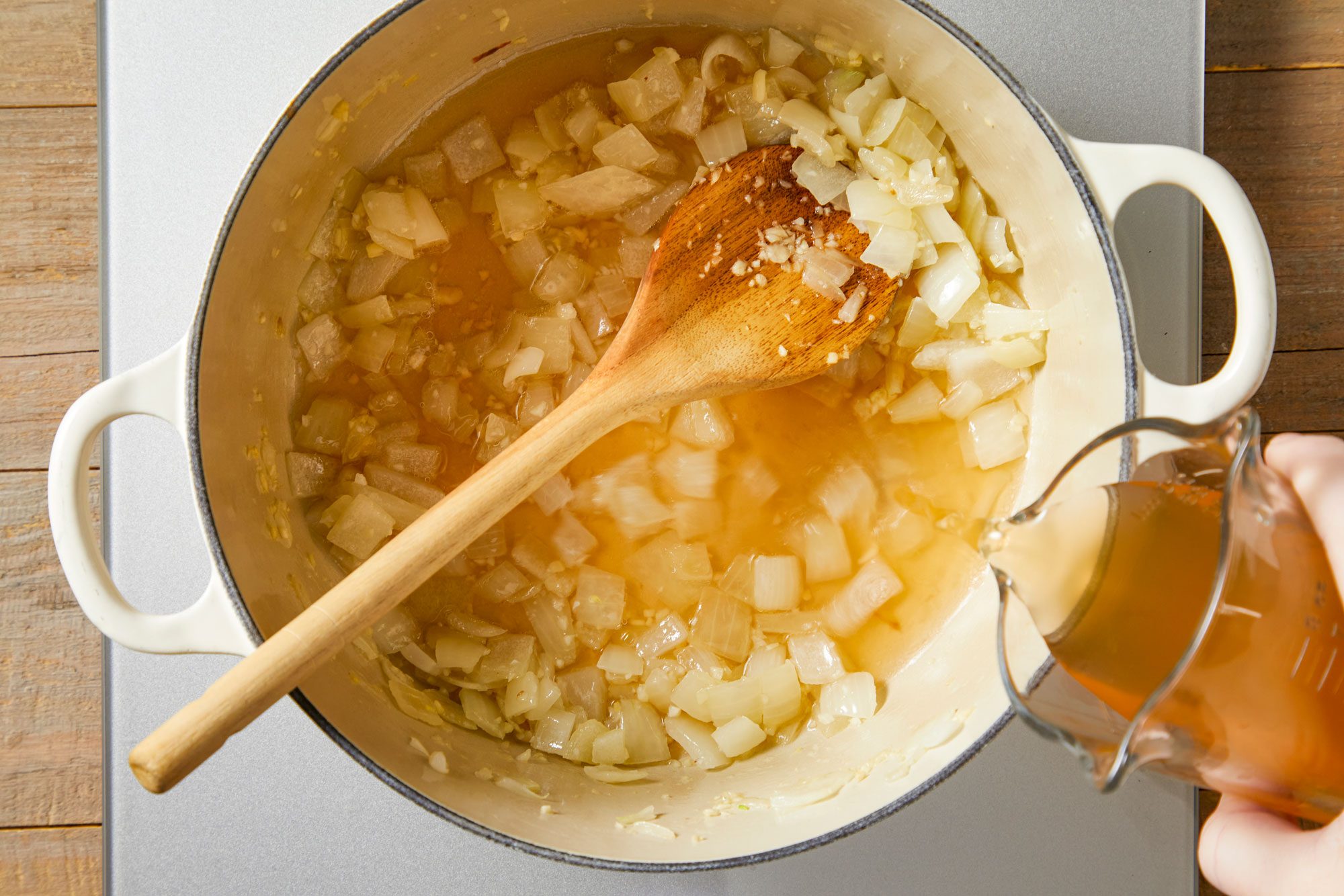In a large Dutch oven, heat oil over medium heat. Cook onion until tender,