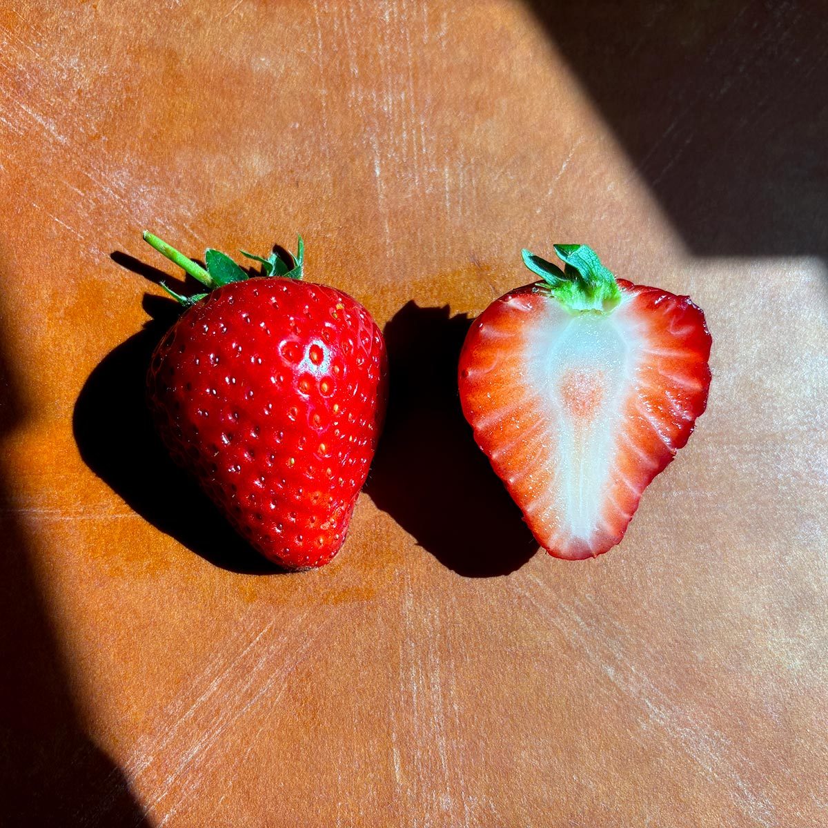 halved erewhon strawberry on a table