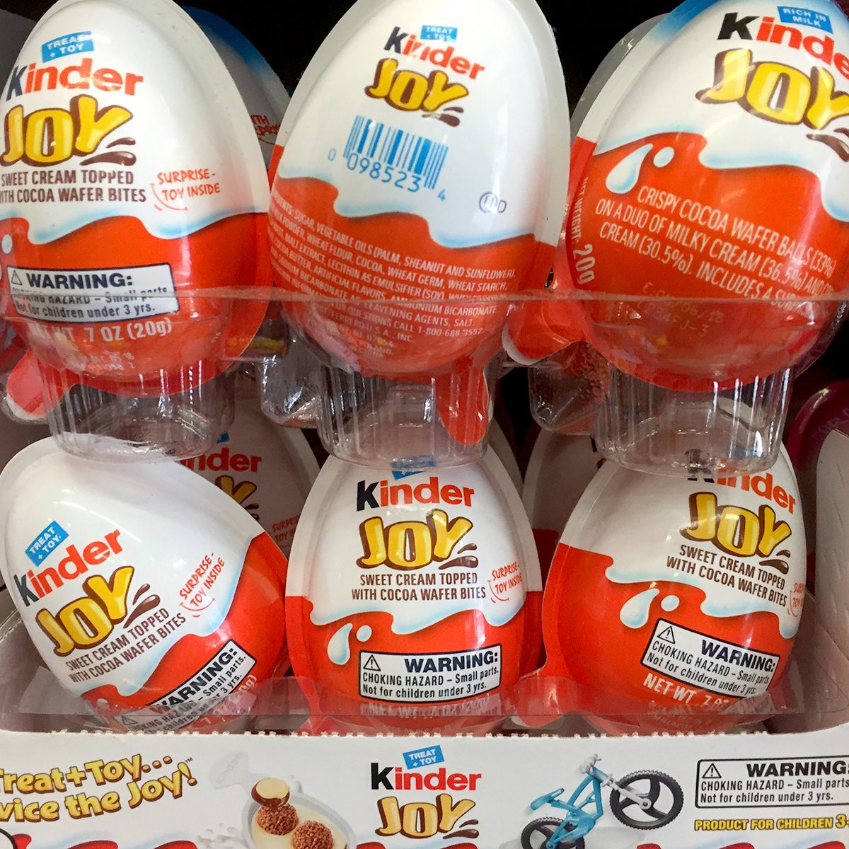 A display of Kinder Joy eggs is shown. The packaging highlights 