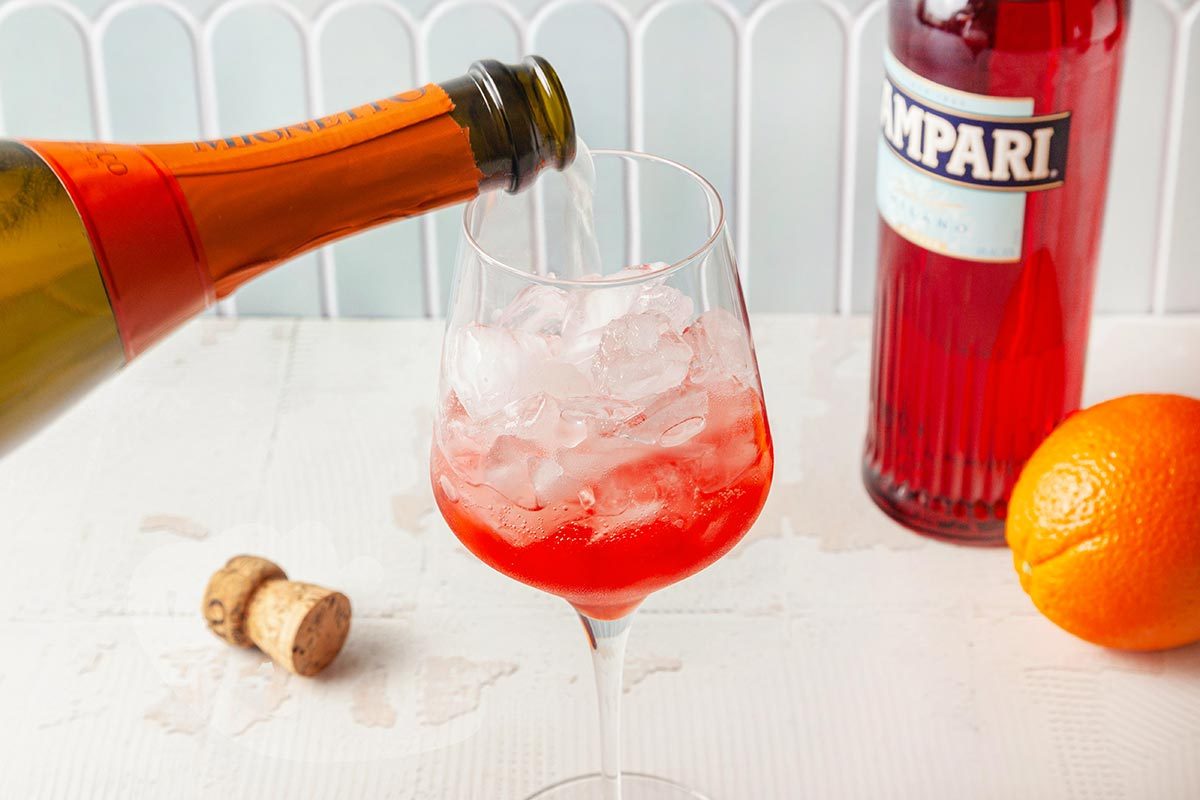 Prosecco is being poring in wine glass