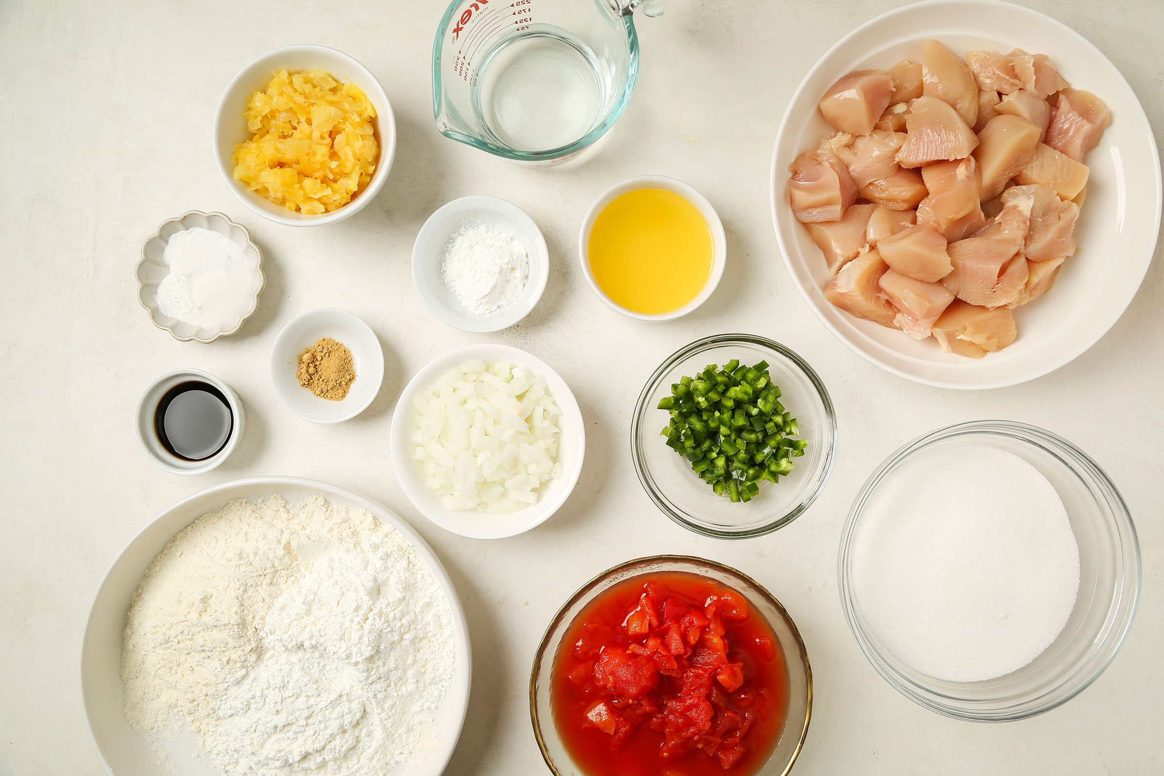 Ingredients for Fried Sweet and Sour Chicken in big and small bowls