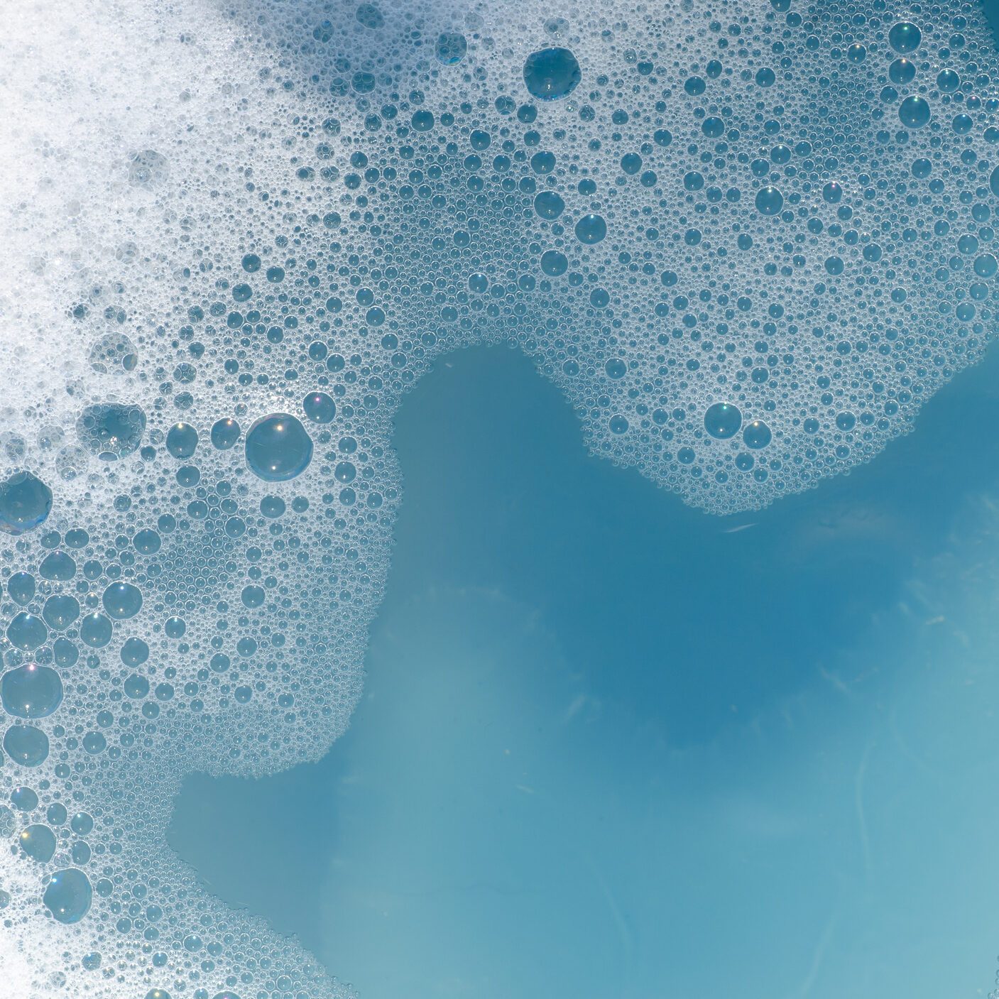 white foam on blue water