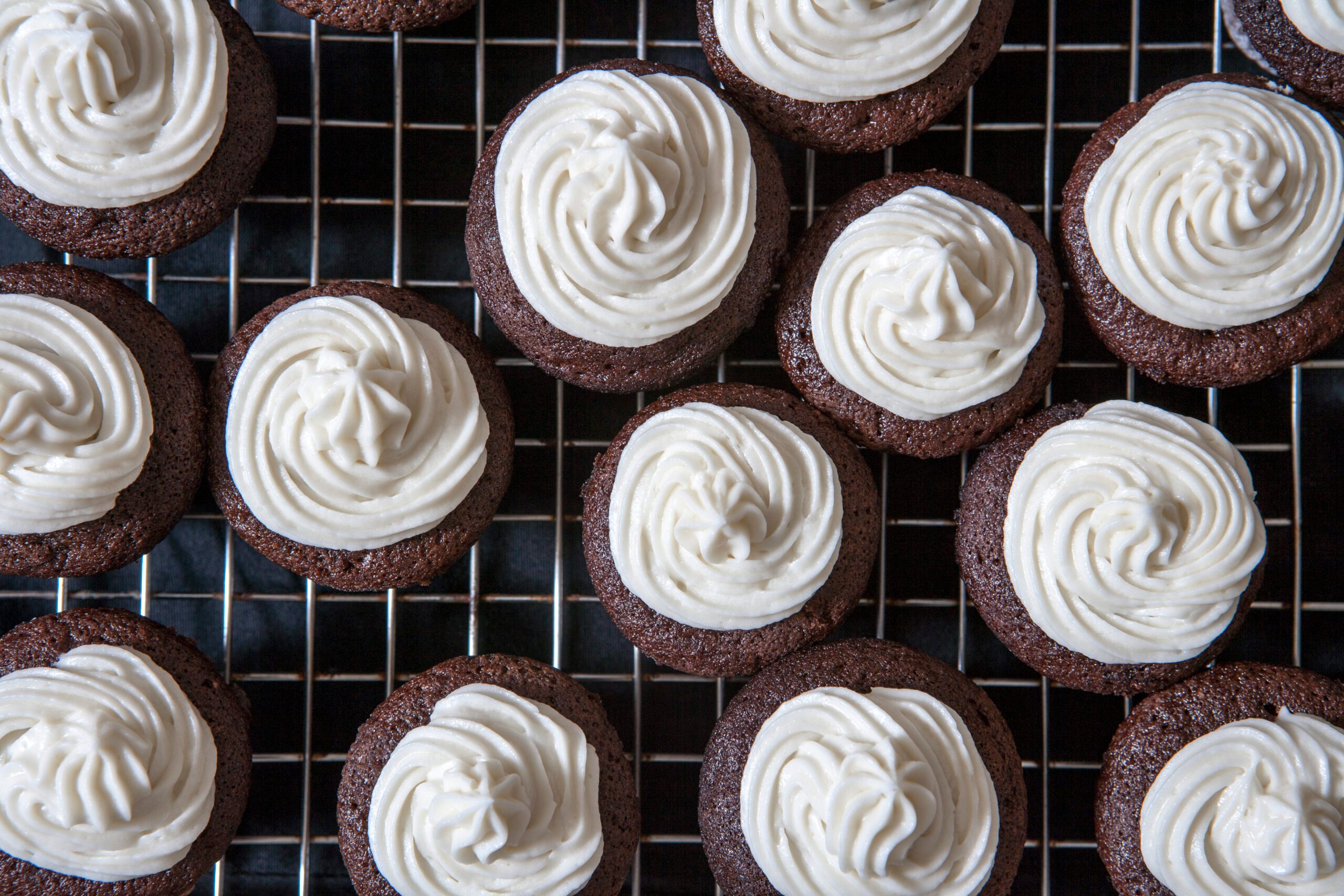 Mini Chocolate Cupcakes with Vanilla Buttercream Frosting on Cooling Rack