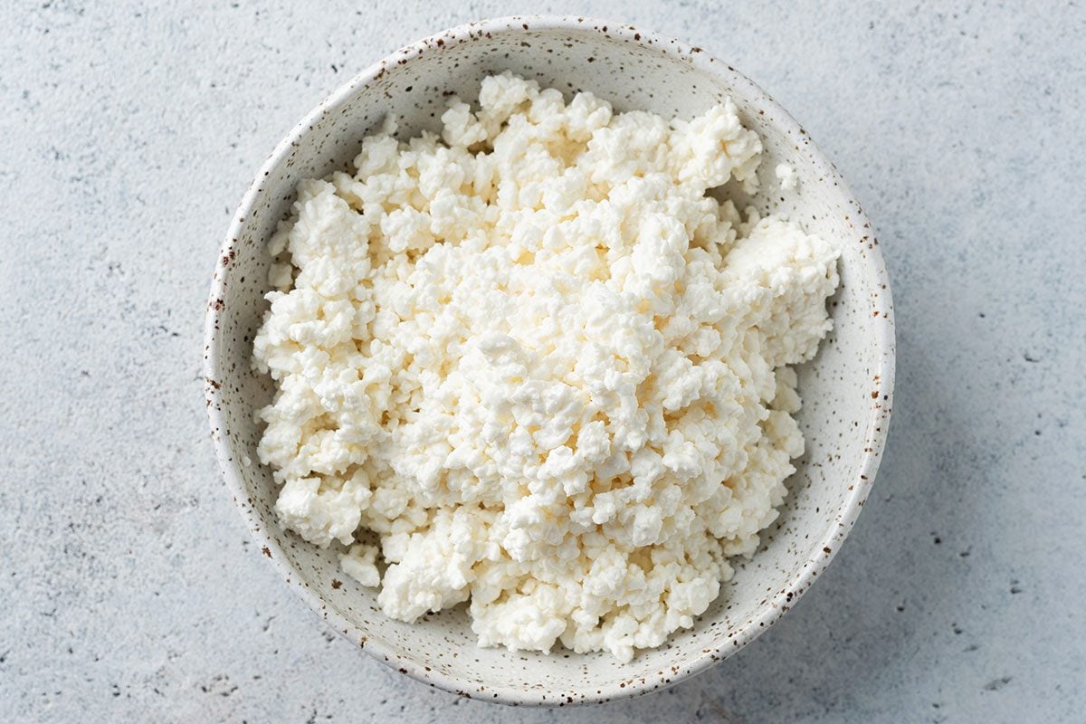 Cottage cheese or curd cheese crumbs in a bowl