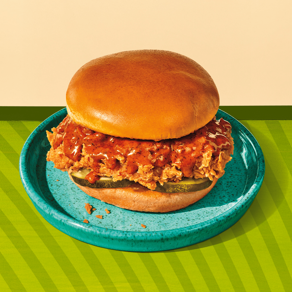 Glazed chicken sandwich on a green background