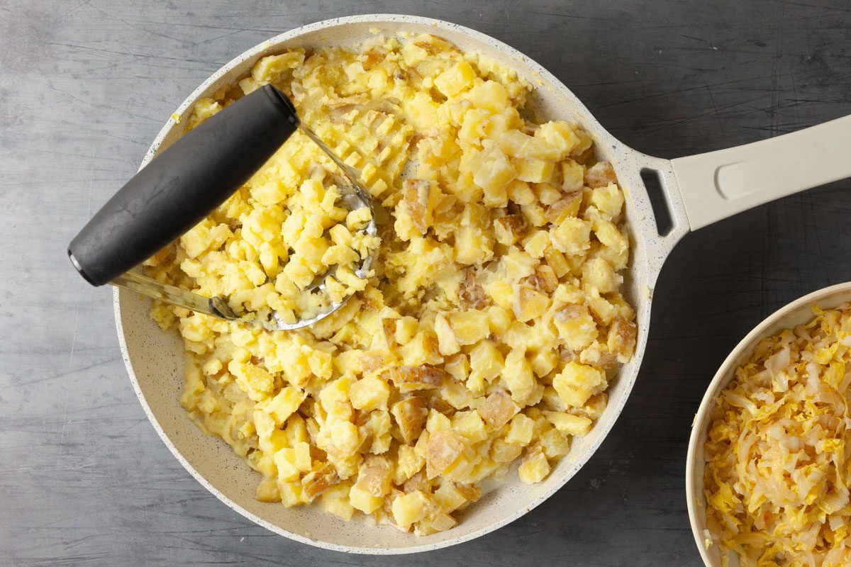 Combine the cooked potatoes with the butter, milk and mustard and mash