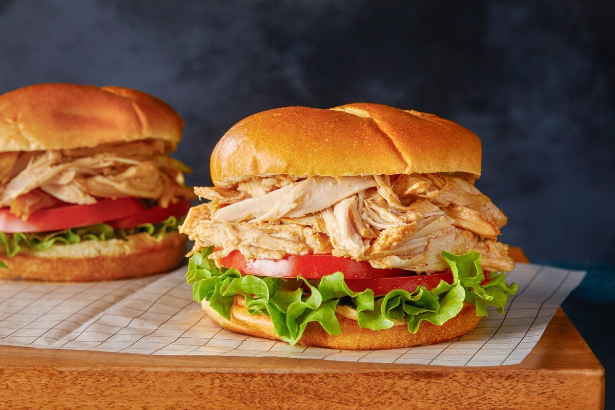 Table view shot of Turkey Barbecue; served on a wooden tray; all set on a dark surface;