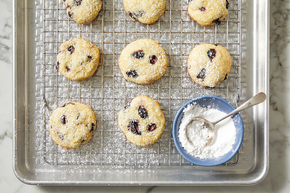 A baking sheet featuring cookies generously sprinkled with powdered sugar, ready to be served.