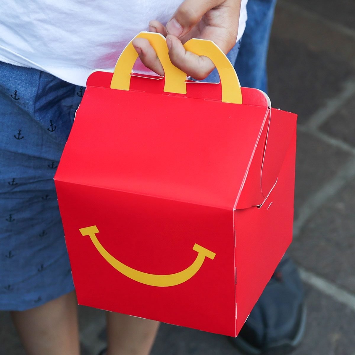 A child holds McDonald's Happy Meal box