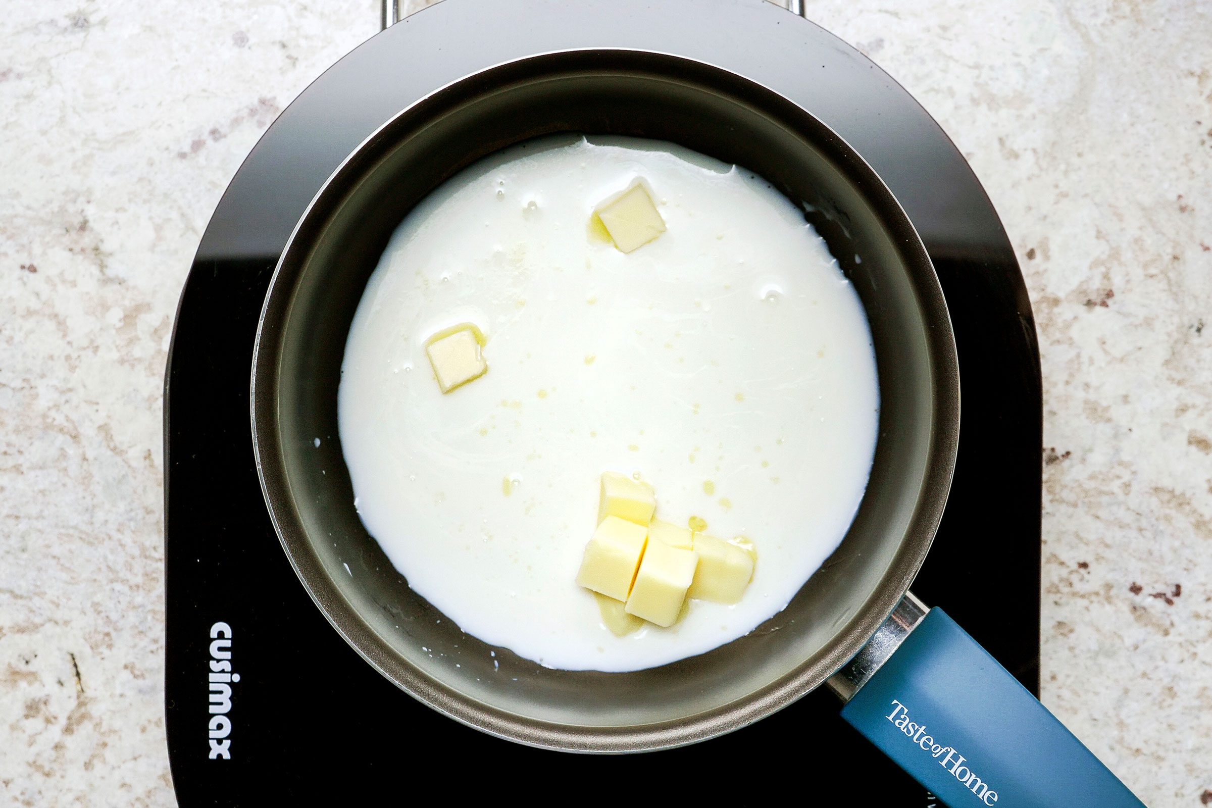Heating milk with 2 tablespoons of butter in a small saucepan until the butter melts.