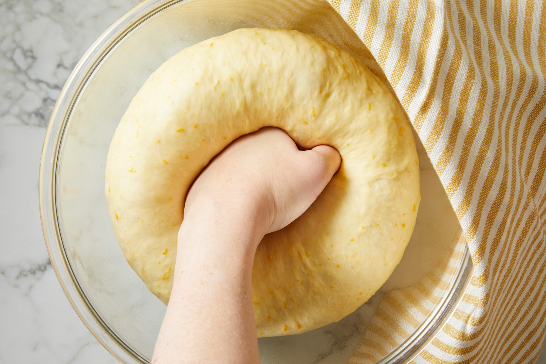 Close shot of Punch down dough; napkin; marble surface;