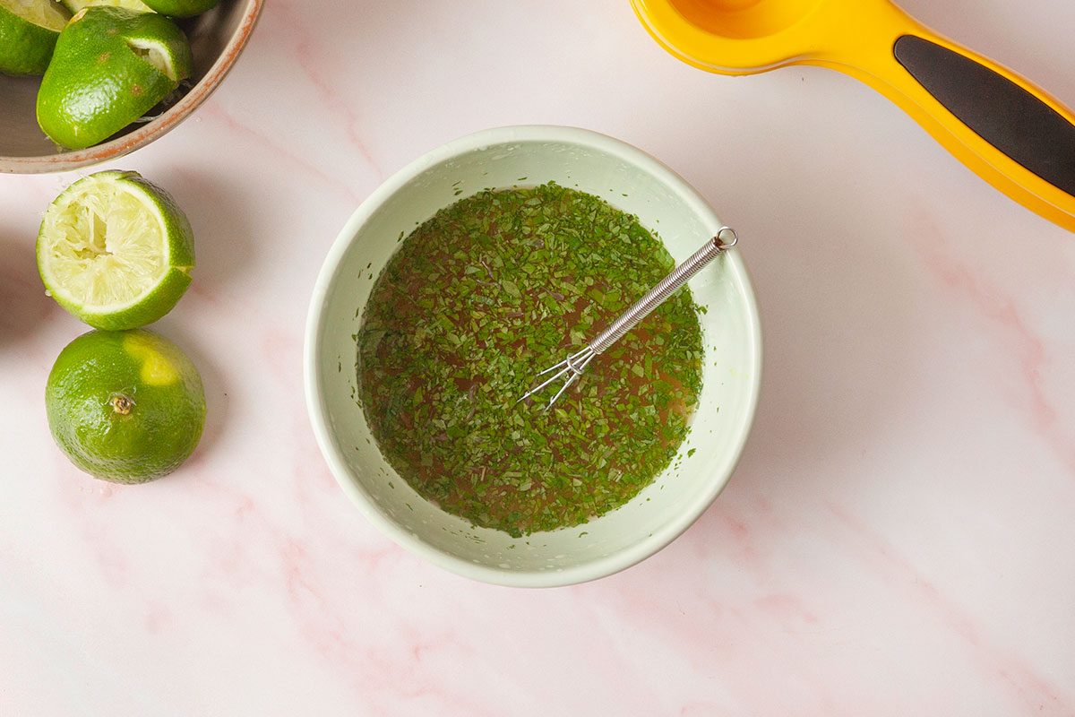 lime juice, honey and mint together mixed in a small bowl