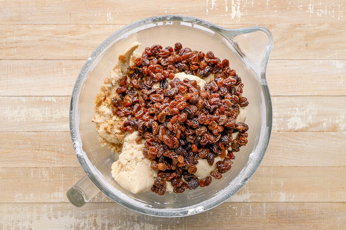 gradually add to creamed mixture and mix well; Stir in nuts and raisins