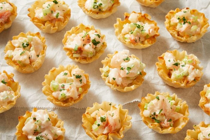 3/4th shot of Shrimp in Phyllo Cups arranged on a sheet of parchment paper