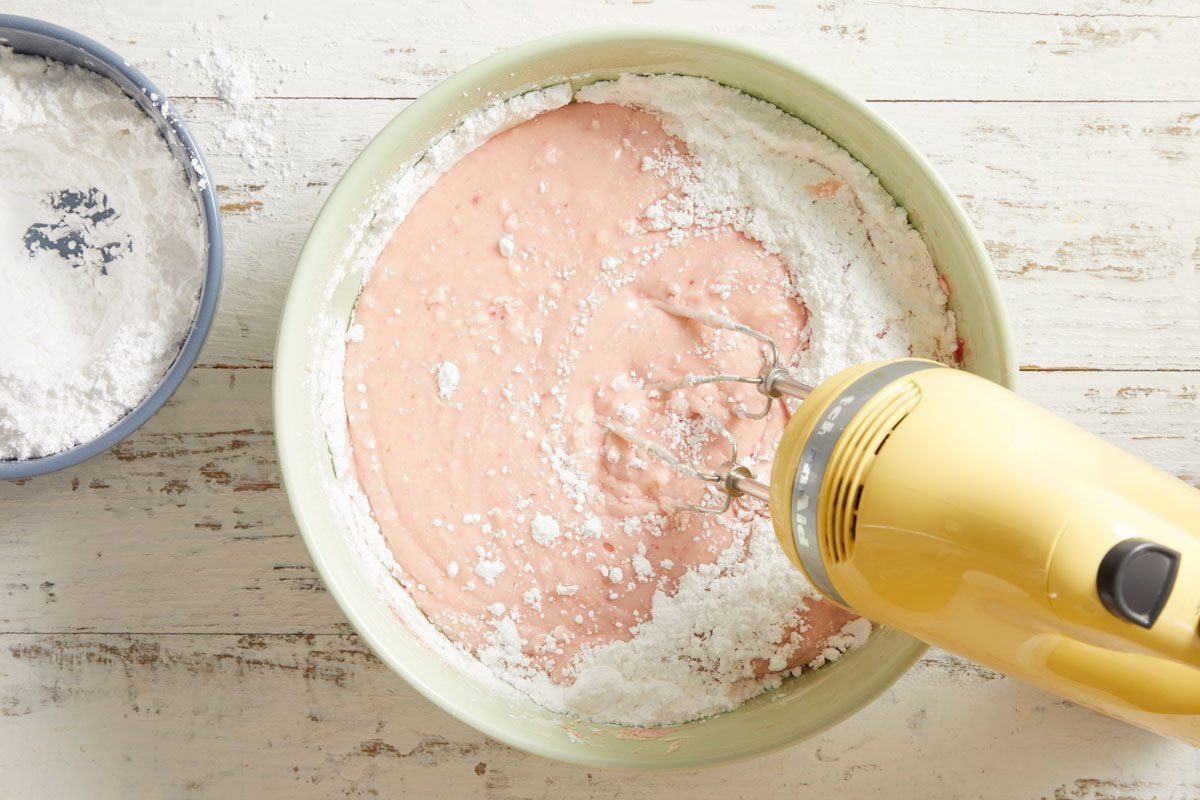 Gradually add confectioners sugar on low speed until blended.