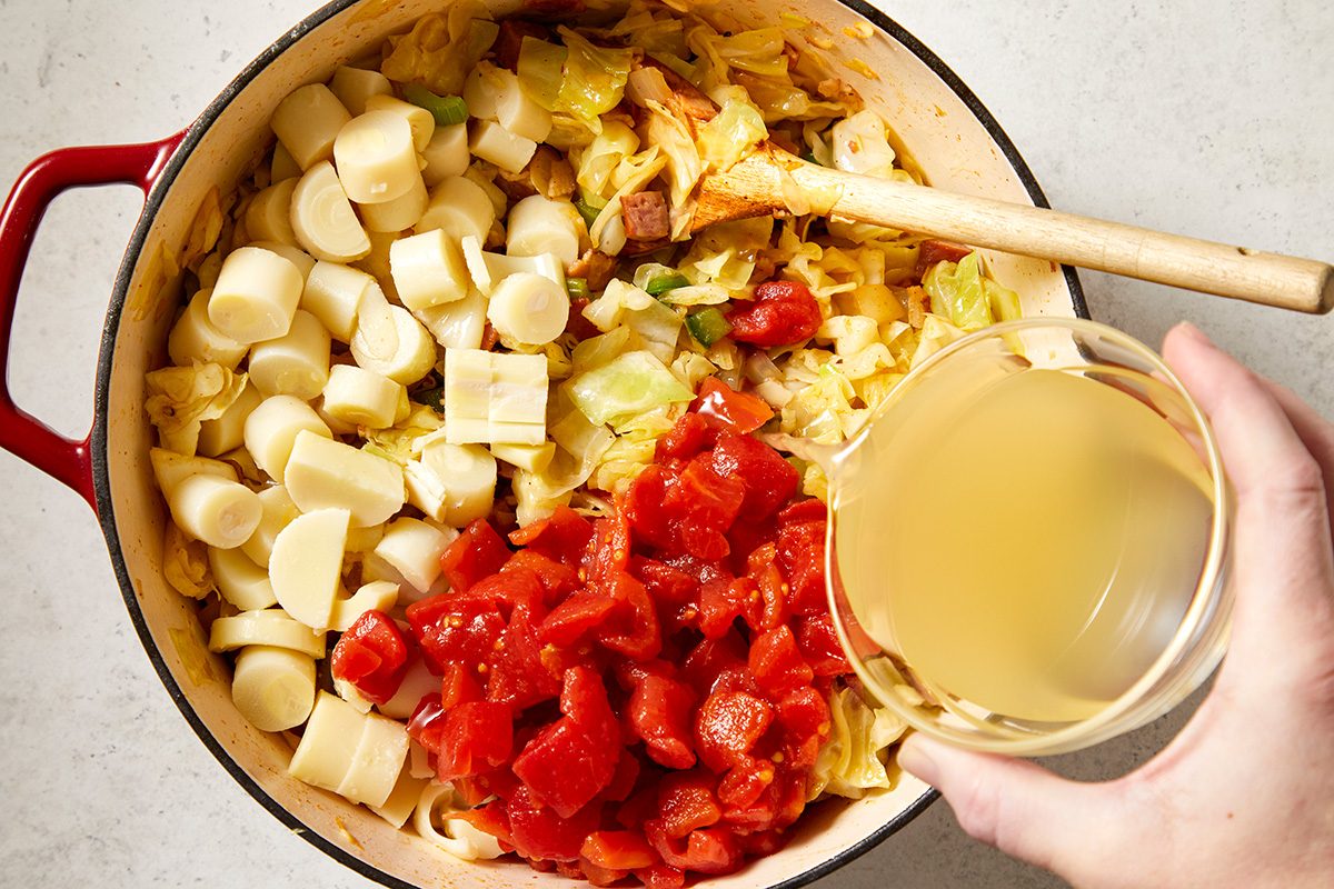 Add hearts of palm, diced tomatoes and broth